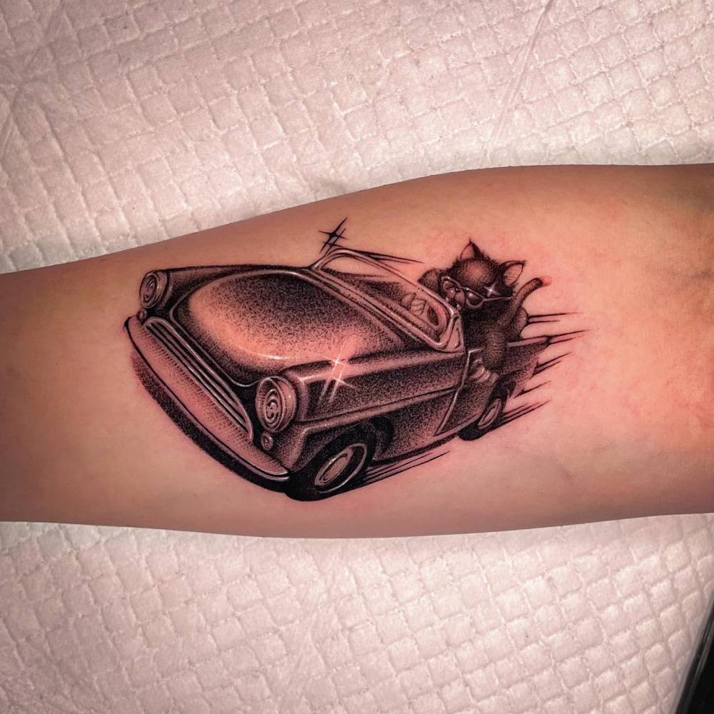 Cat racer tattoo located on the inner forearm, dotwork style.