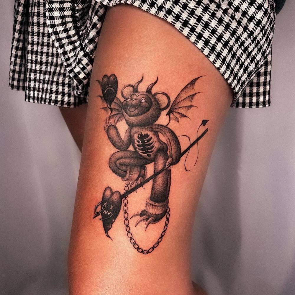Devil teddy bear tattoo located on the thigh, dotwork style.