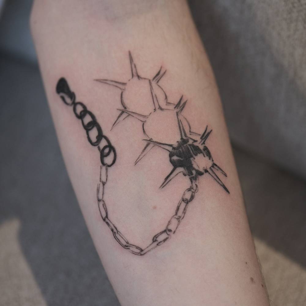 Blackwork style flail tattoo located on the inner forearm.
