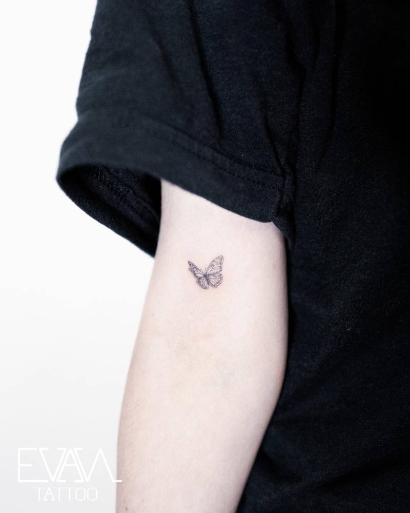 Fine line style butterfly tattoo done on the bicep.