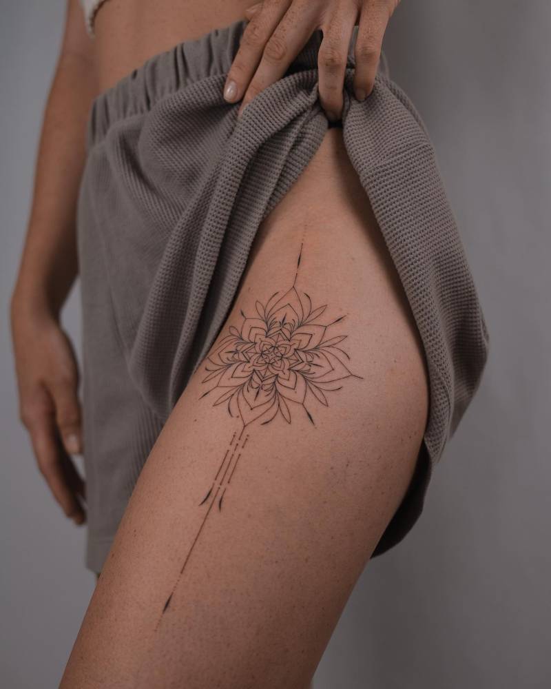Hand poked ornamental tattoo placed on the thigh.