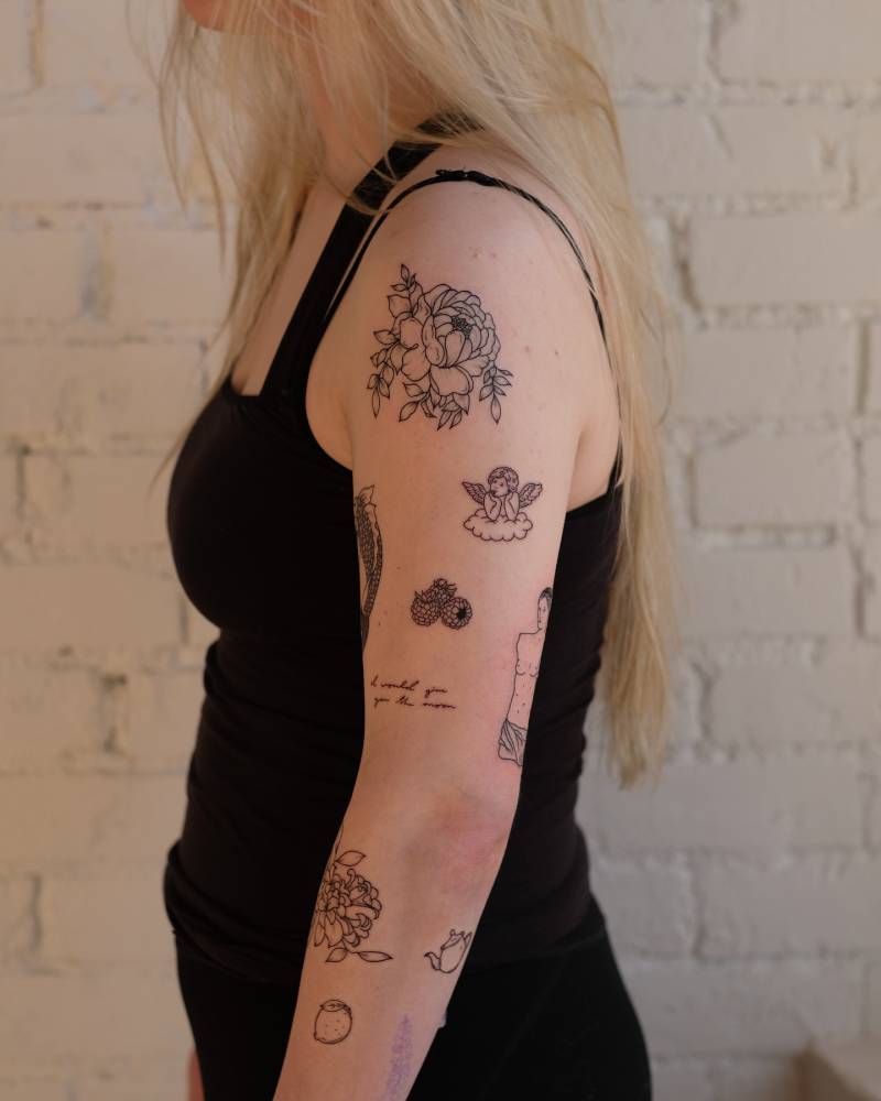 Arm composition tattoos in illustrative style.