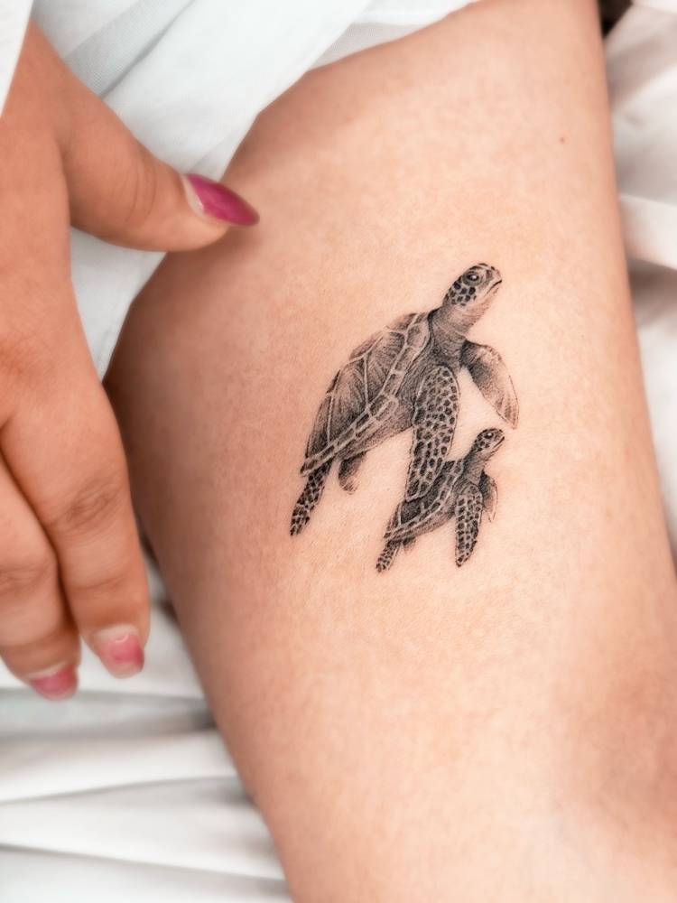 Turtles tattooed on the inner forearm, done in micro-realistic style.