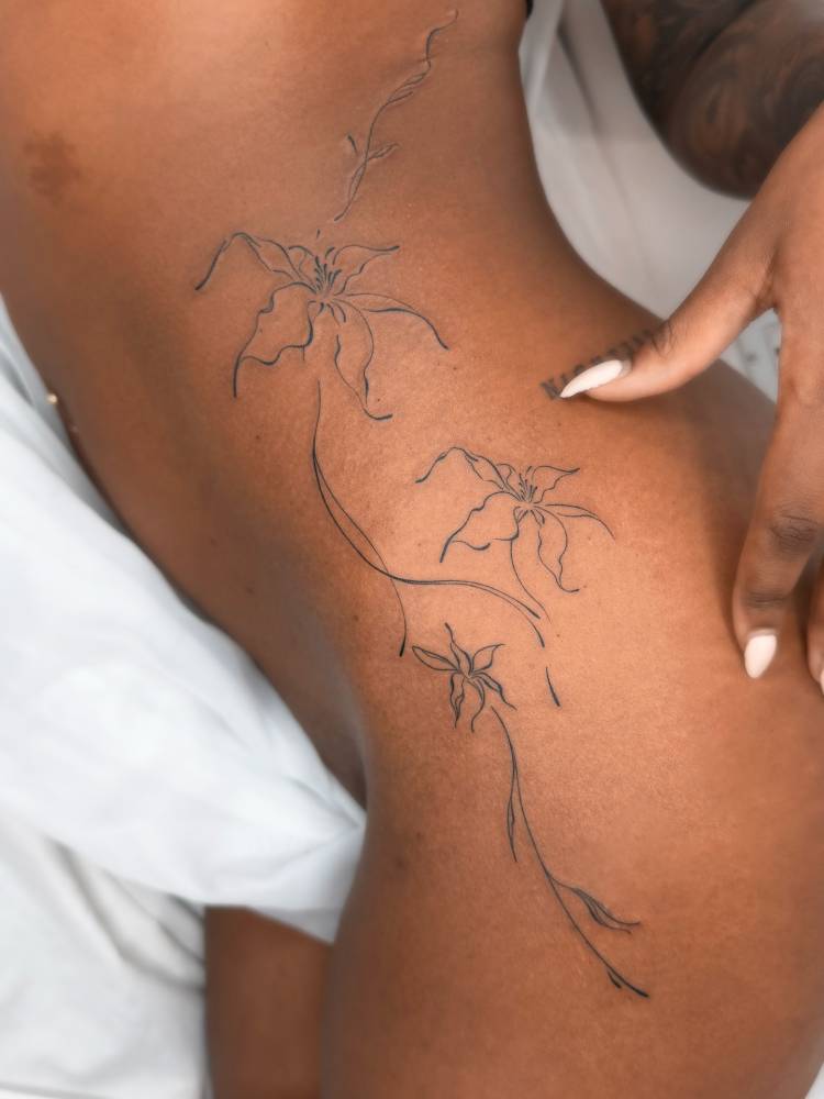 Line art style abstract lily flowers tattoo.