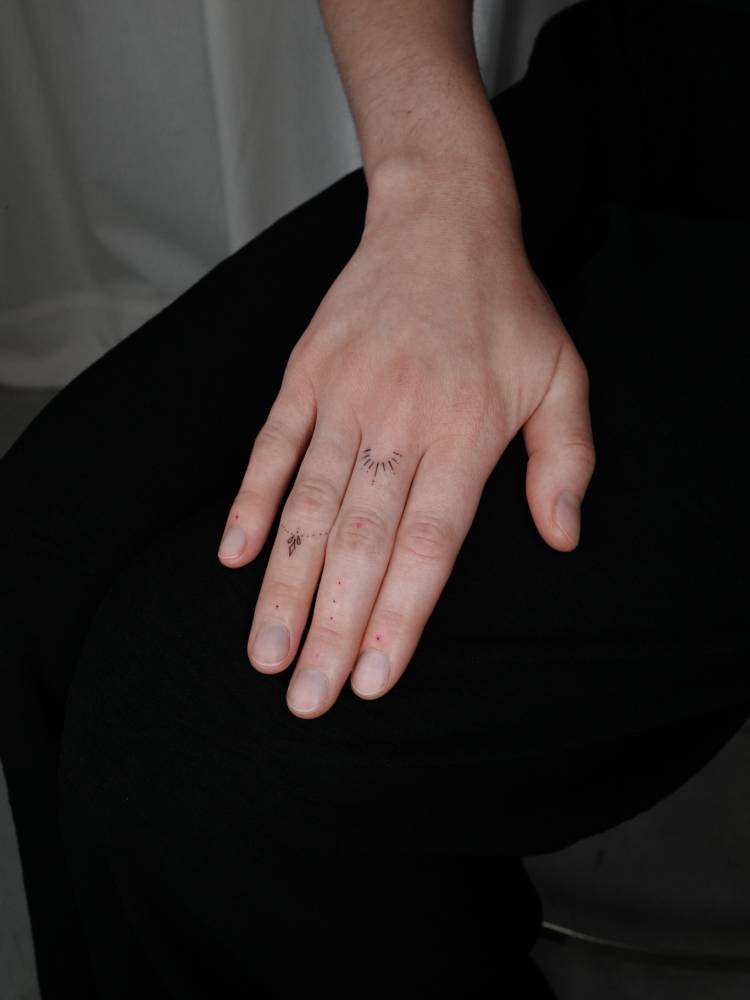 Ornamental finger composition tattoos in minimalistic style.