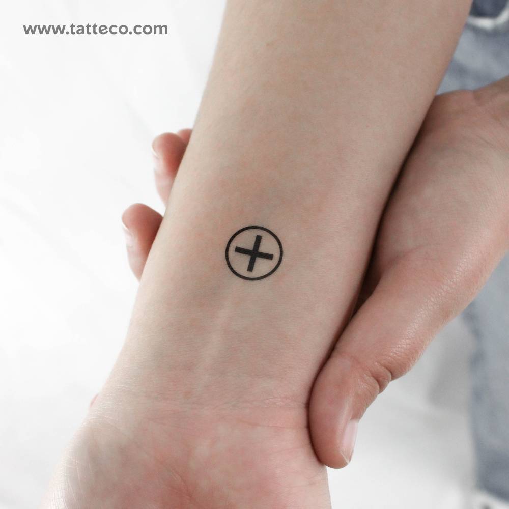Minimalistic style Ailm symbol temporary tattoo located on the wrist.
