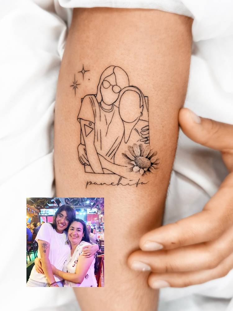 Mother and daughter portrait tattoo located on the forearm.