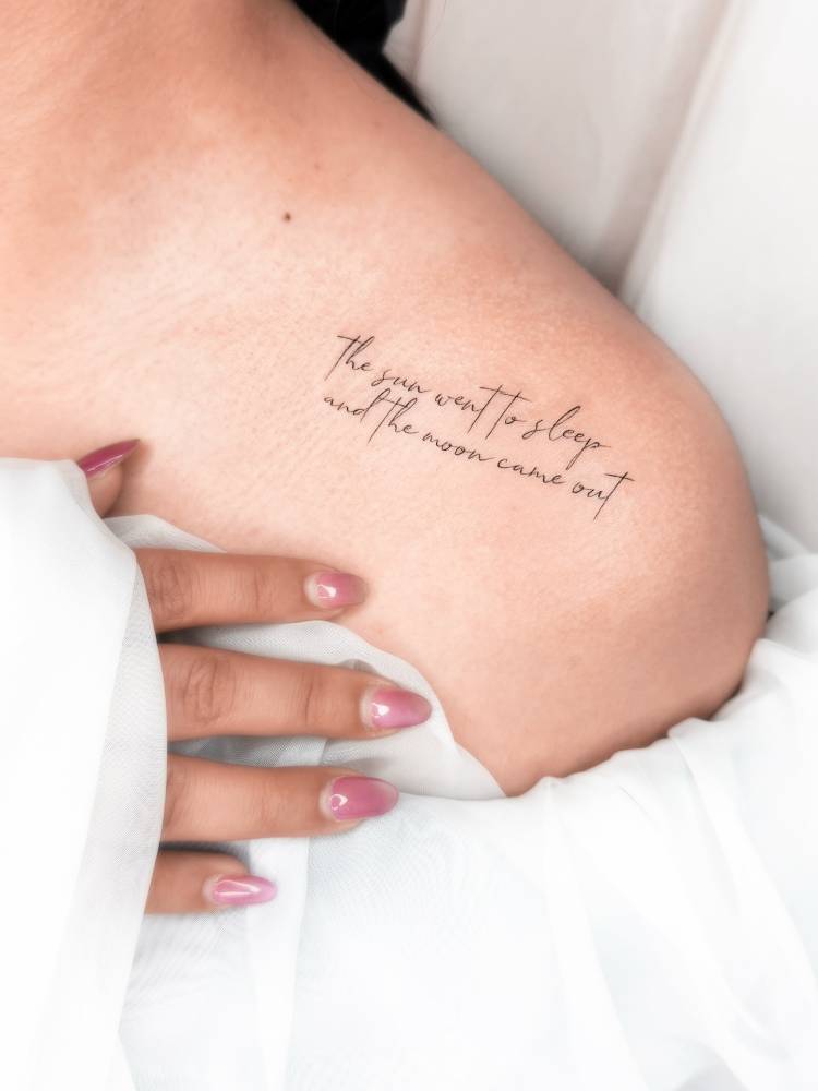 "The sun went to sleep and the moon came out" lettering tattoo done on the shoulder.