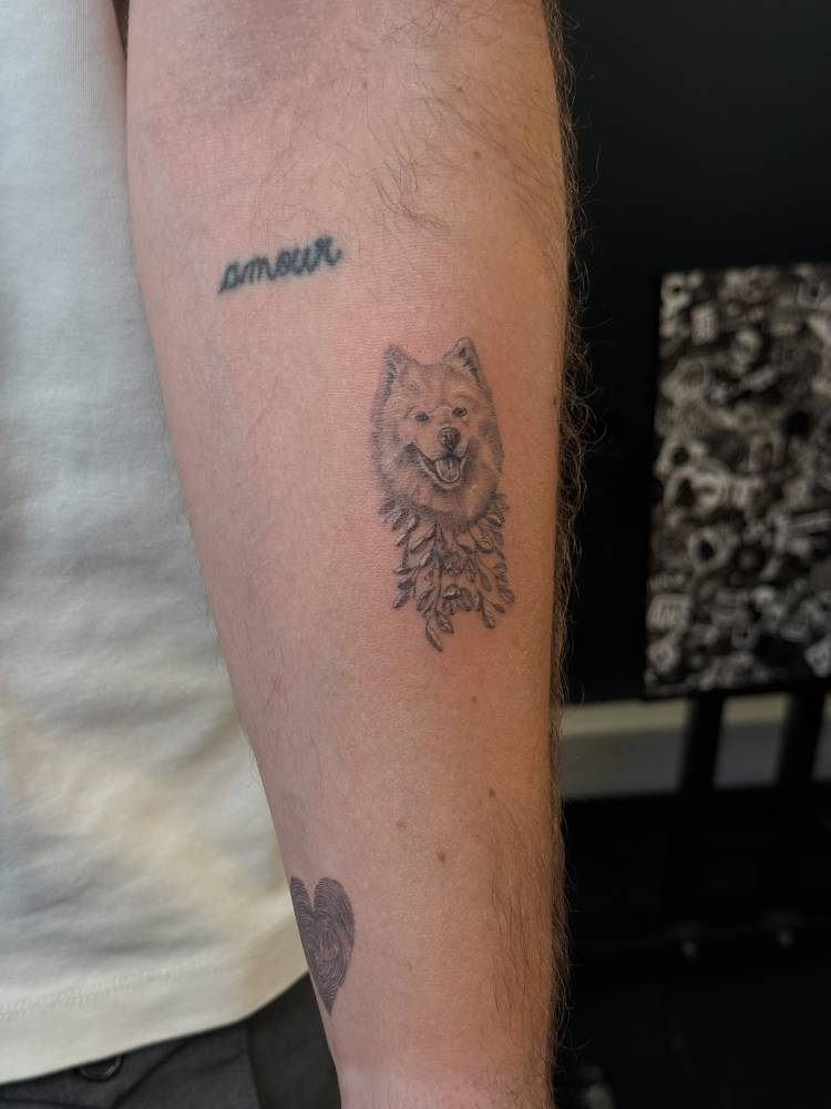 Chow Chow portrait tattoo in micro-realistic style located on the inner forearm.