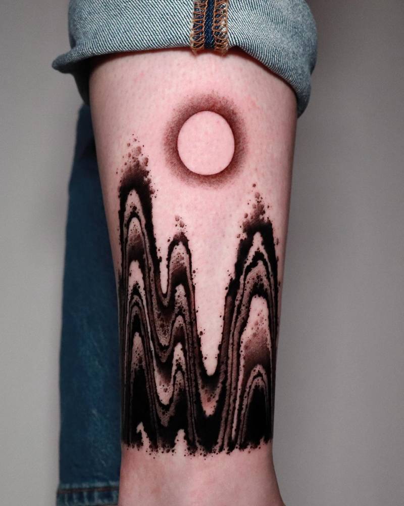 Abstract mountain flow tattoo located on the shin.