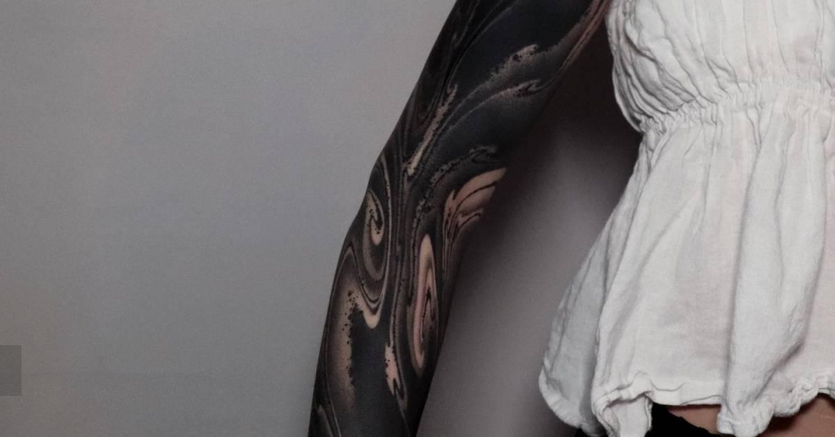 Blackwork style flow cover up tattoo sleeve.