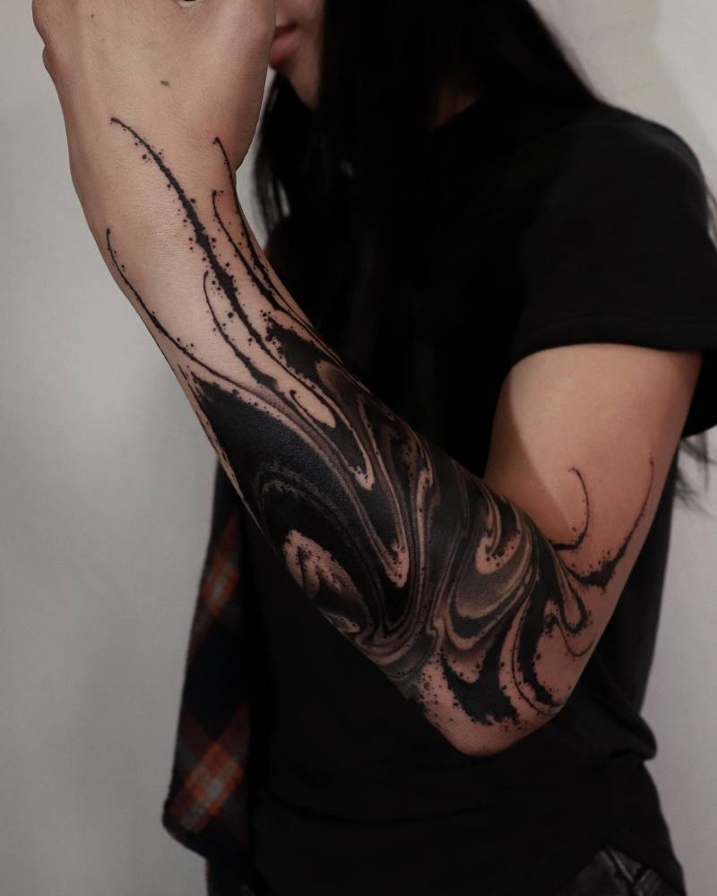 Blackwork style flow tattoo placed on the forearm.