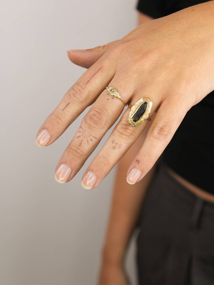 Ornamental finger composition tattoos.