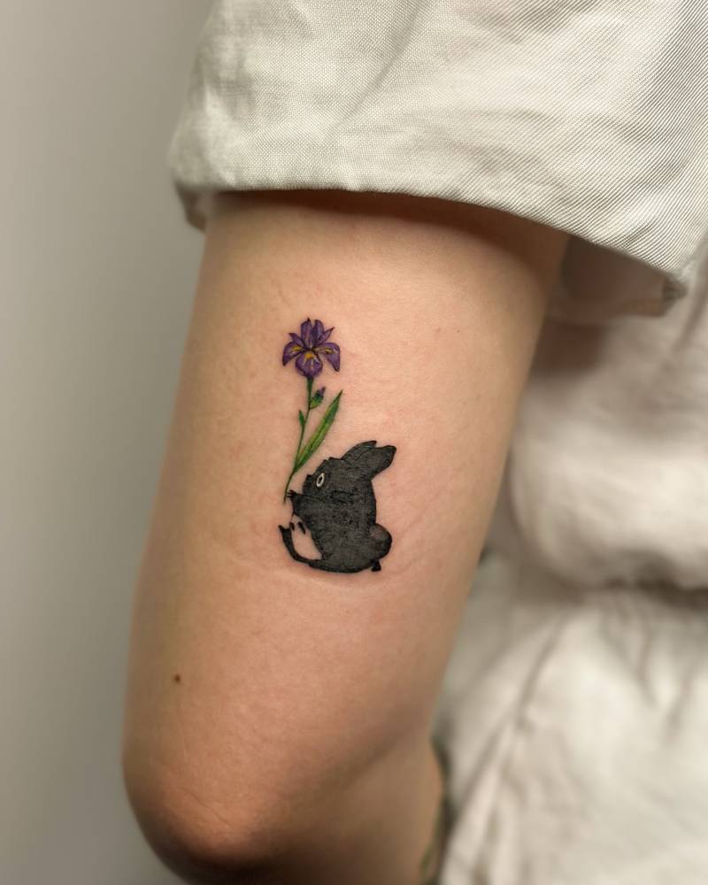 Chuu Totoro tattoo located on the tricep, done in cartoon style.