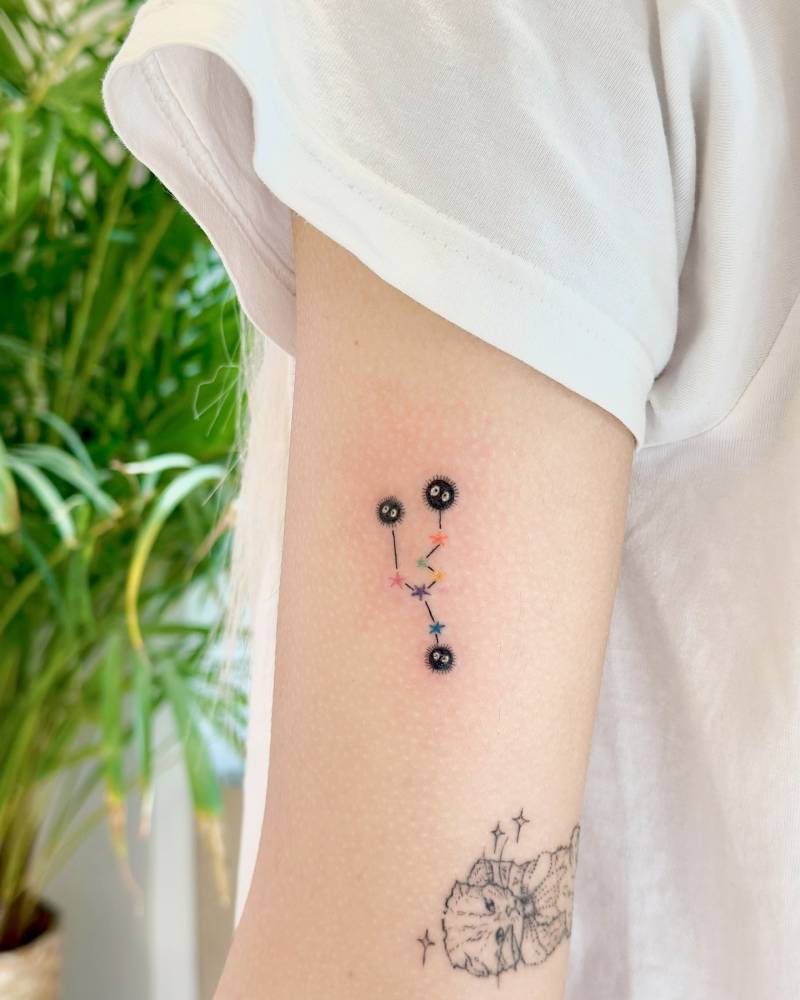 Soot Sprites and Taurus constellation tattooed on the upper arm.