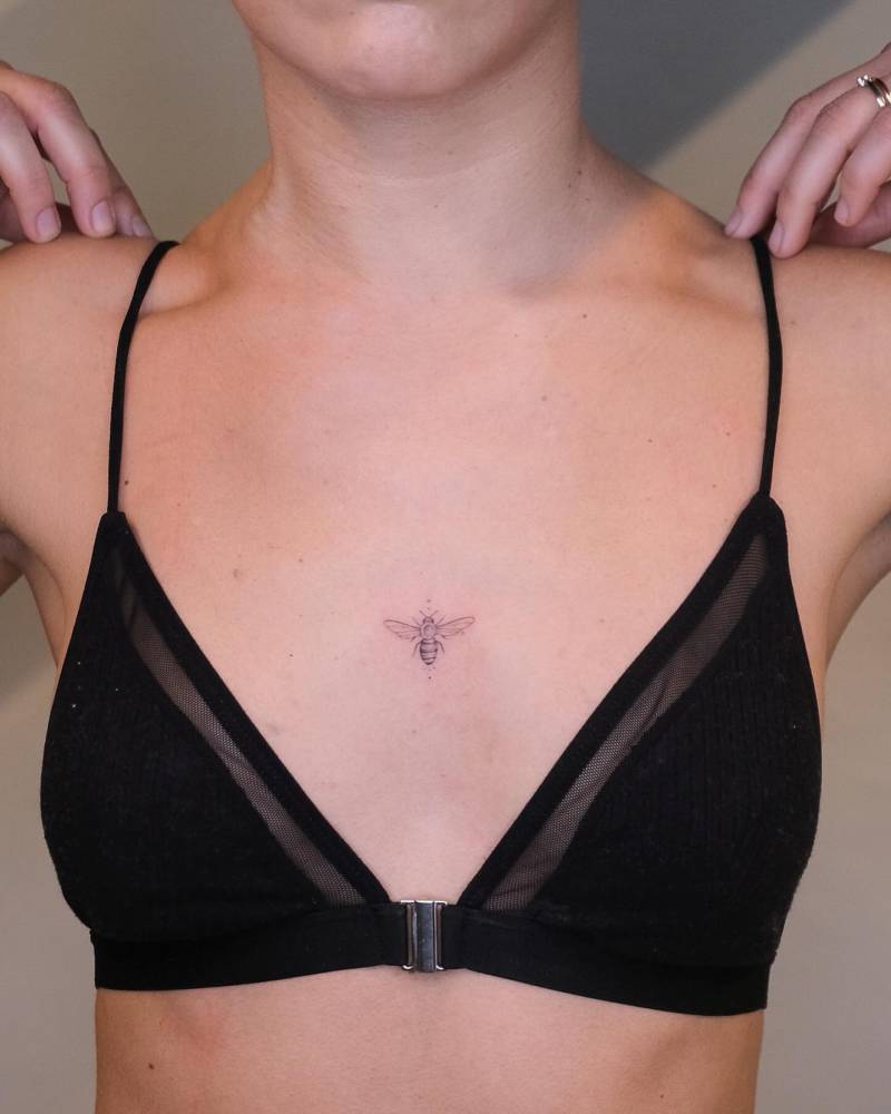 Single needle bee tattoo located on the sternum.