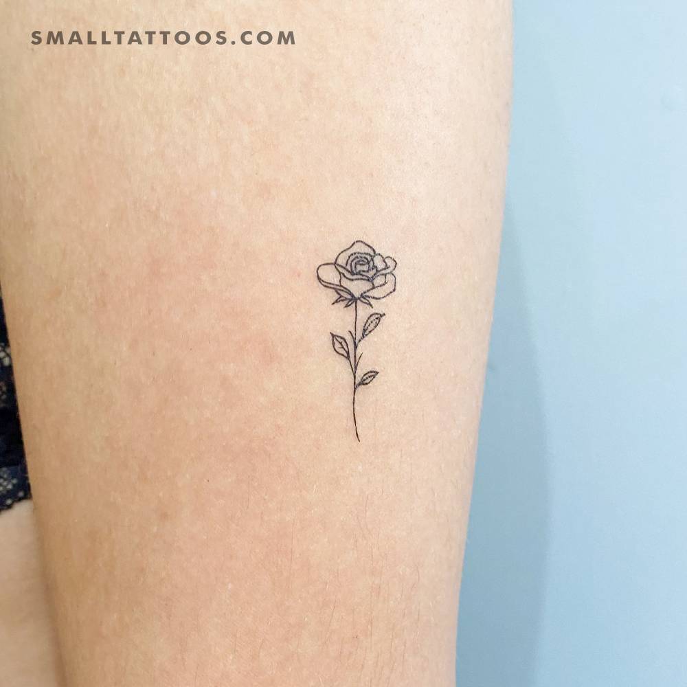 Fine line style rose temporary tattoo located on the thigh.