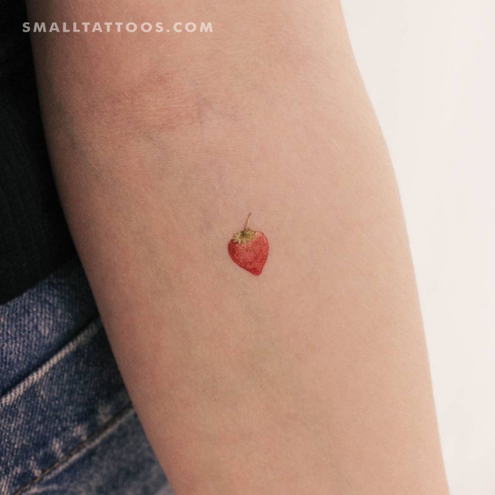 Watercolor strawberry temporary tattoo placed on the inner forearm.