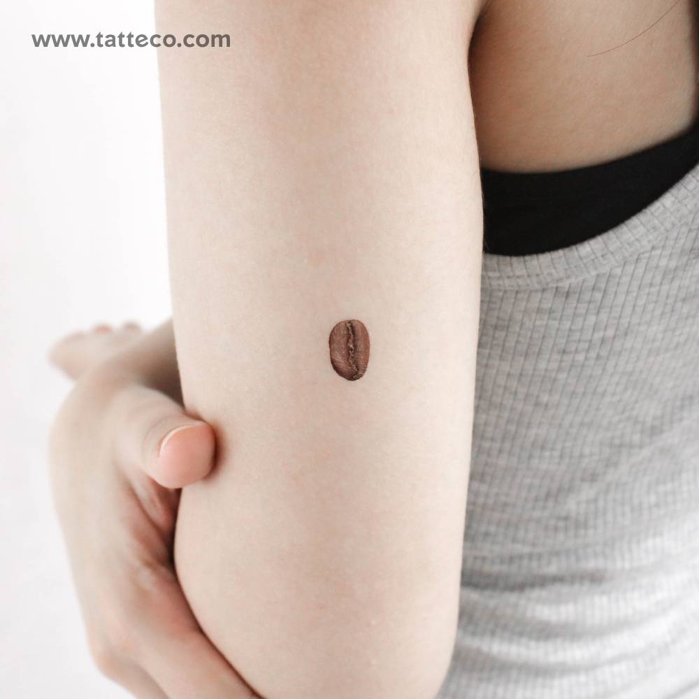 Coffee bean temporary tattoo located on the tricep.