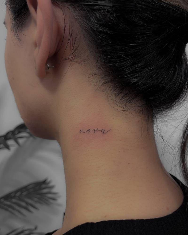 "Nova" lettering tattoo located on the neck.