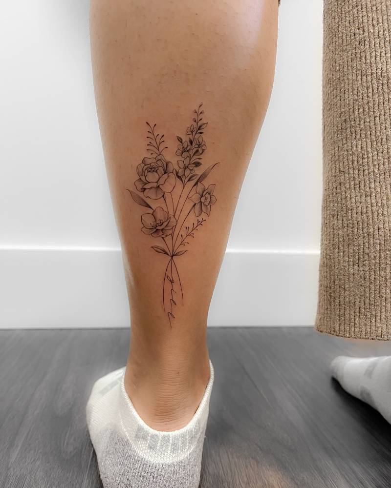 Illustrative style flower bouquet tattoo placed on the achilles.