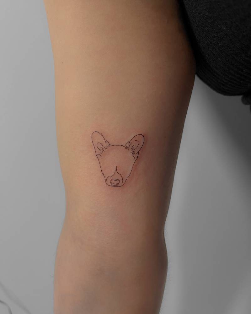 Fine line style dog portrait tattoo located on the inner arm.