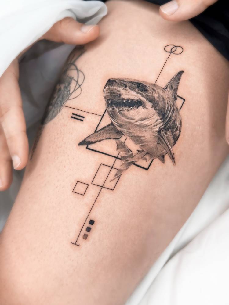 Shark tattoo in micro-realistic style located on the thigh.