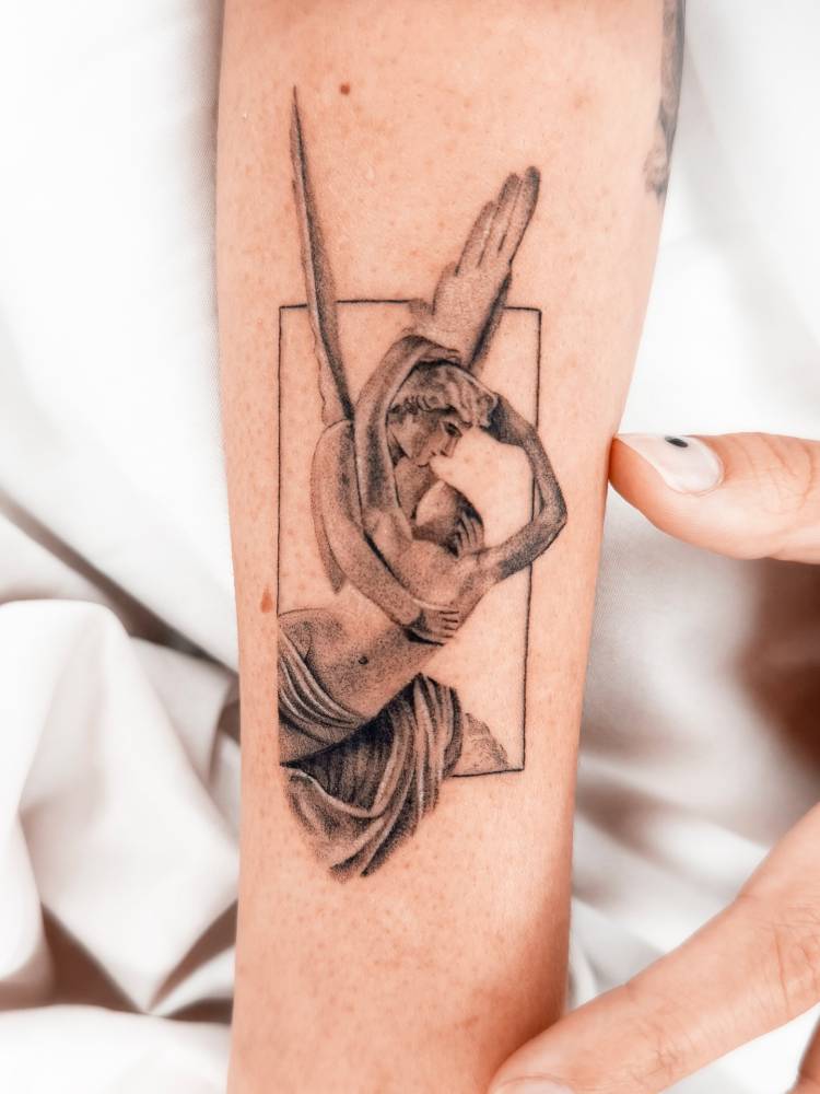 Classical style 'Psyche Revived by Cupid's Kiss' tattooed on the forearm.