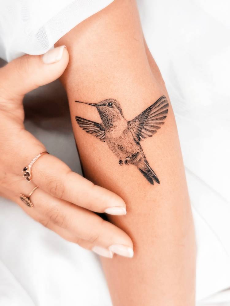 Hummingbird tattoo placed on the forearm, done in micro-realistic style.