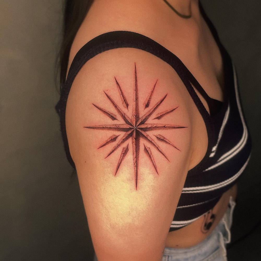 Illustrative style star tattoo placed on the shoulder.