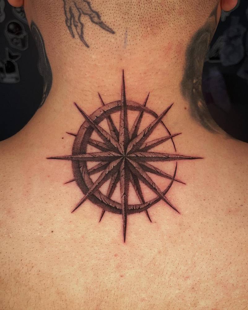 Moon and star tattoo in illustrative style done on the back of the neck.