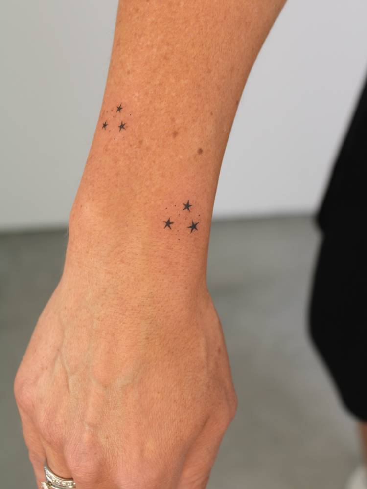 Minimalistic style Harry Potter book stars tattoo done on the wrist.
