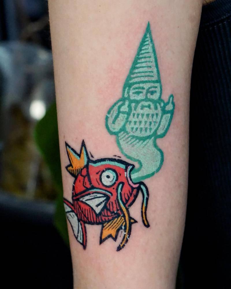 Magikarp and gnome tattoo in pop art style located on the upper arm.