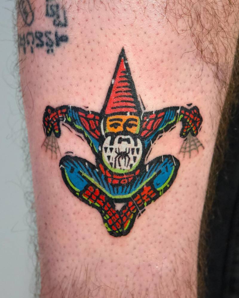 Spider-gnome tattoo located on the shin, done in pop art style.