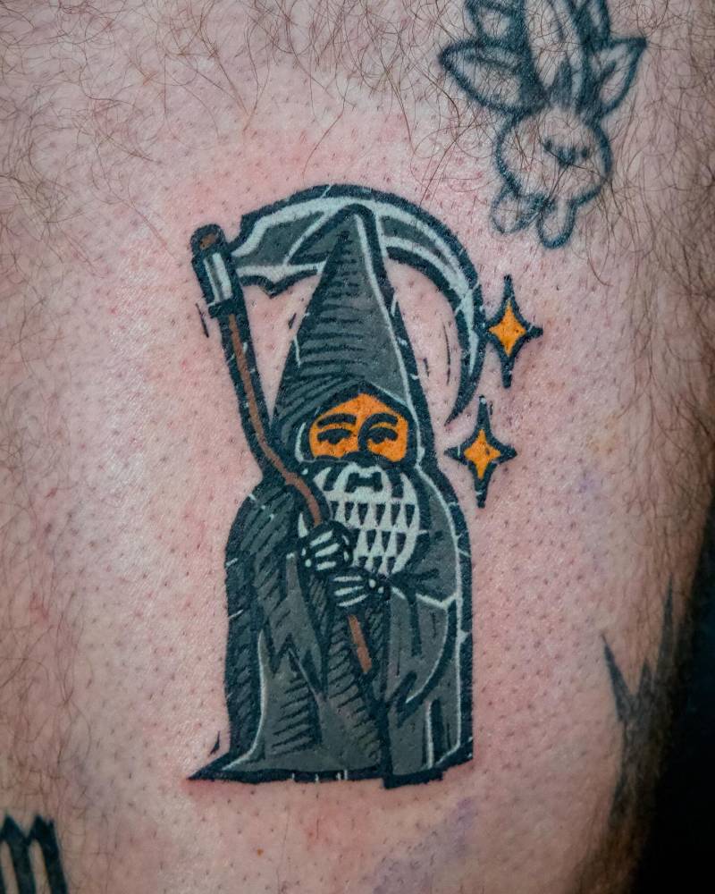 Grim Reaper gnome tattoo in pop art style placed on the thigh.