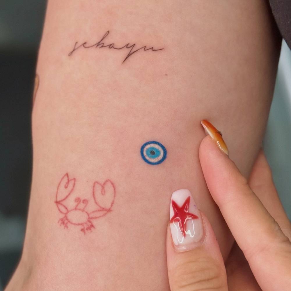 Minimalistic style Nazar tattoo placed on the inner arm.