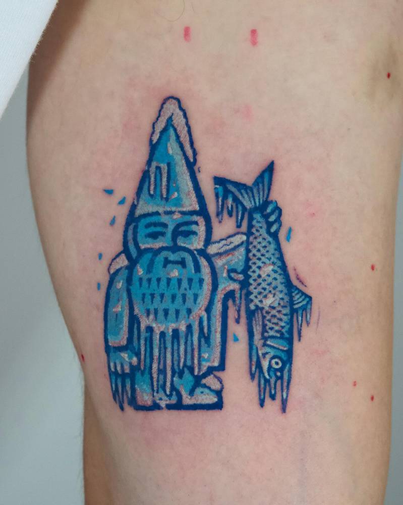 Frozen gnome tattoo in cartoon style located on the inner arm.