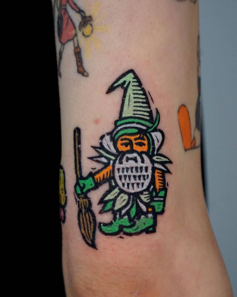 Pop art style gnome tattoo located on the tricep.