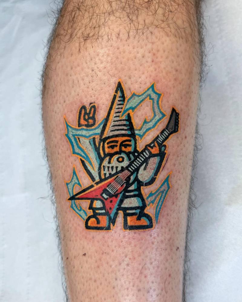Gnome guitarist tattooed on the calf, done in pop art style.