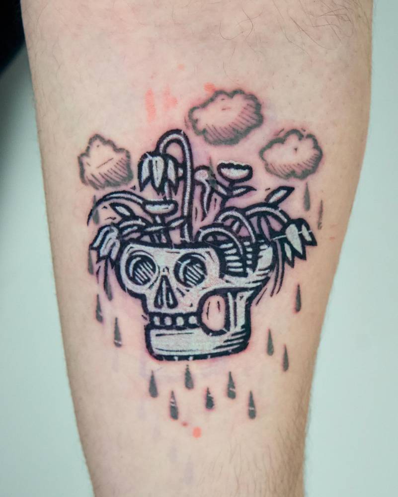 Skull flower pot tattoo located on the inner forearm, pop art style.