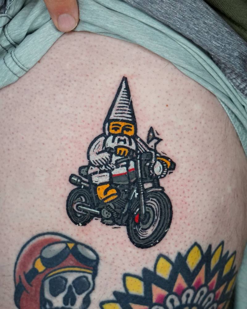 Gnome bike rider tattoo located on thigh, pop art style.