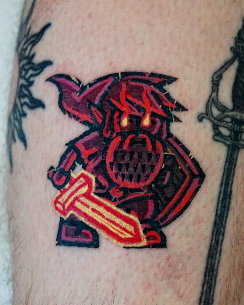 Pop art style gnome Link tattoo located on the shin.