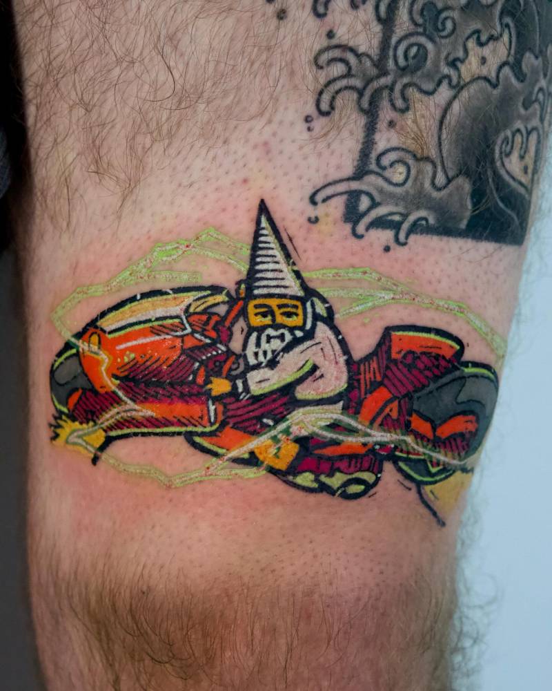 Akira gnome tattoo located on the thigh, cartoon style.
