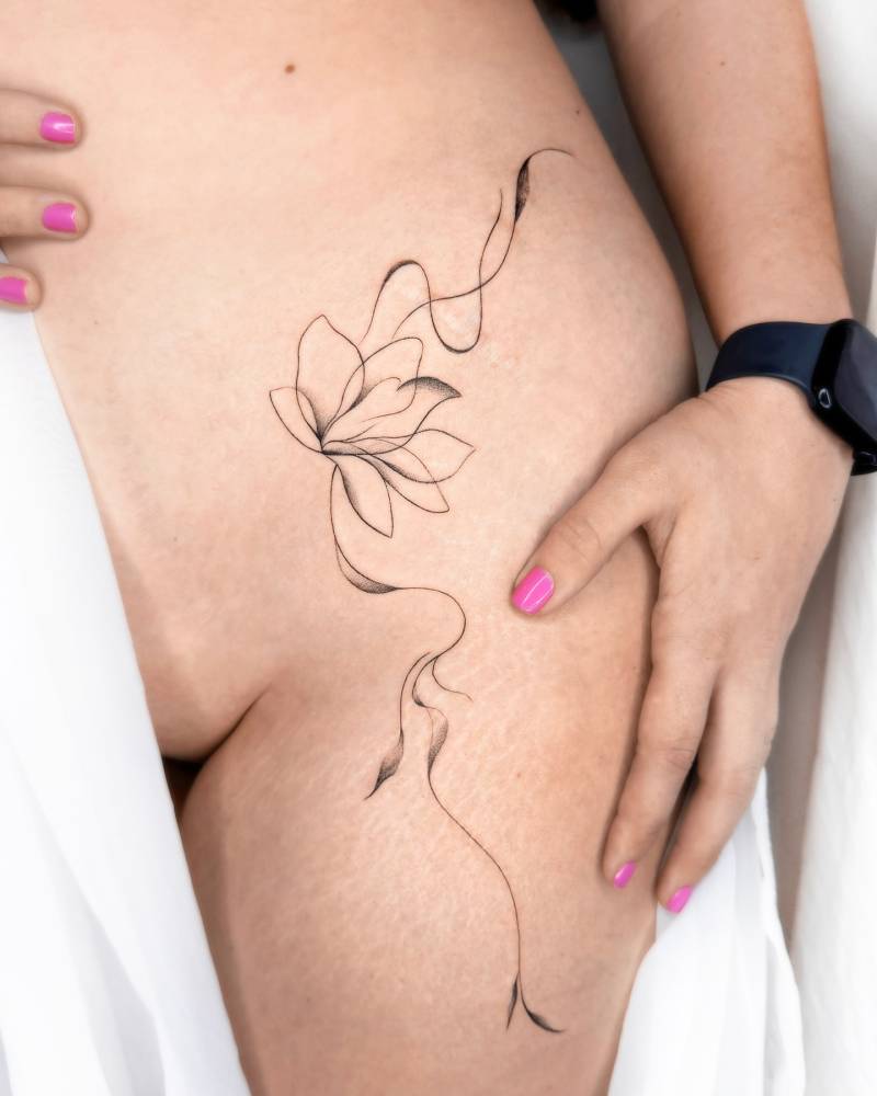 Illustrative style Lotus flower tattoo located on the hip.