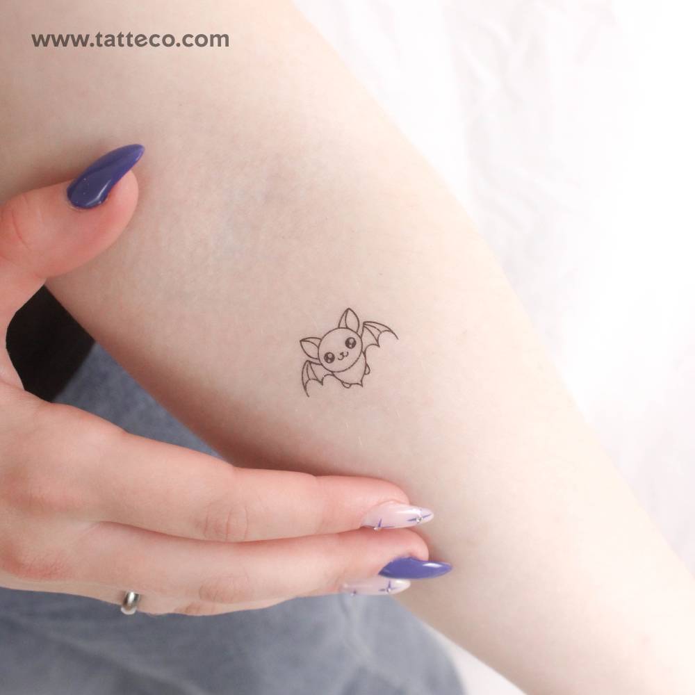 Tiny fine line style bat temporary tattoo located on the inner forearm.