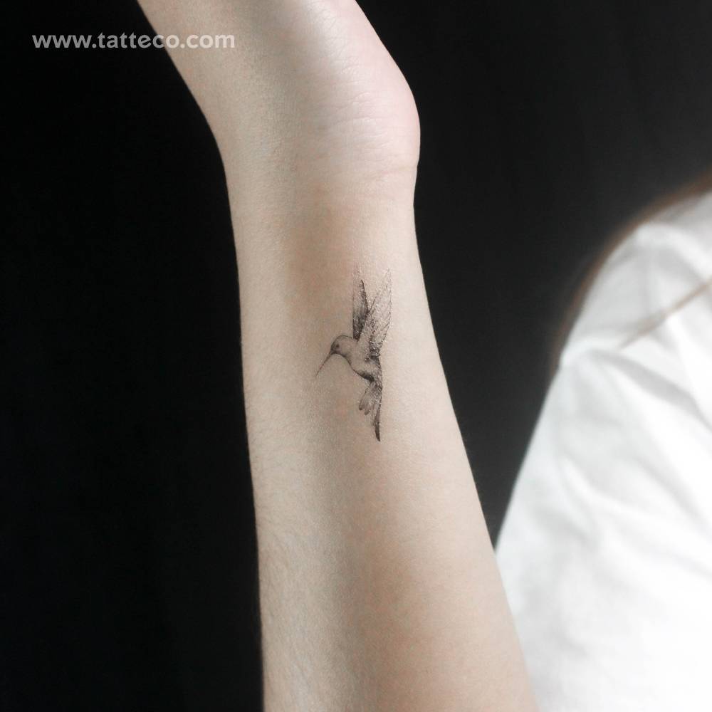 Flying micro-realistic hummingbird temporary tattoo placed on the wrist.