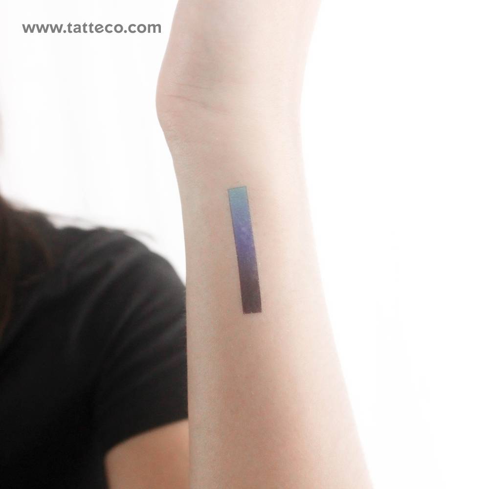 Blue ink spectrum temporary tattoo located on the wrist.