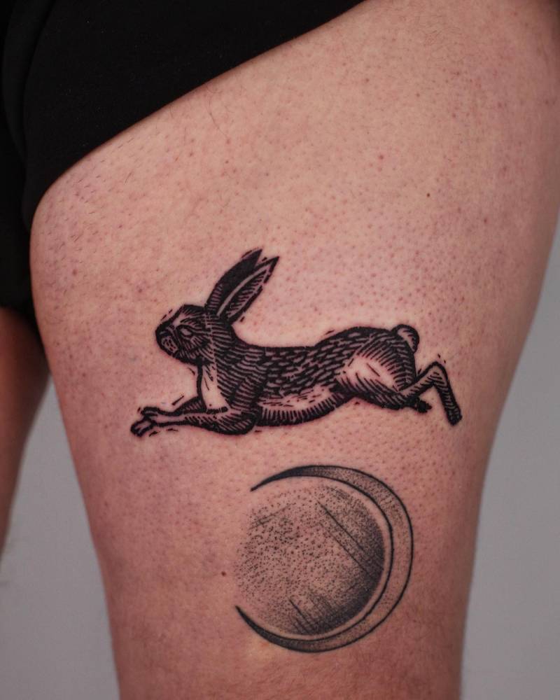 Hare tattoo in engraving style located on the thigh.