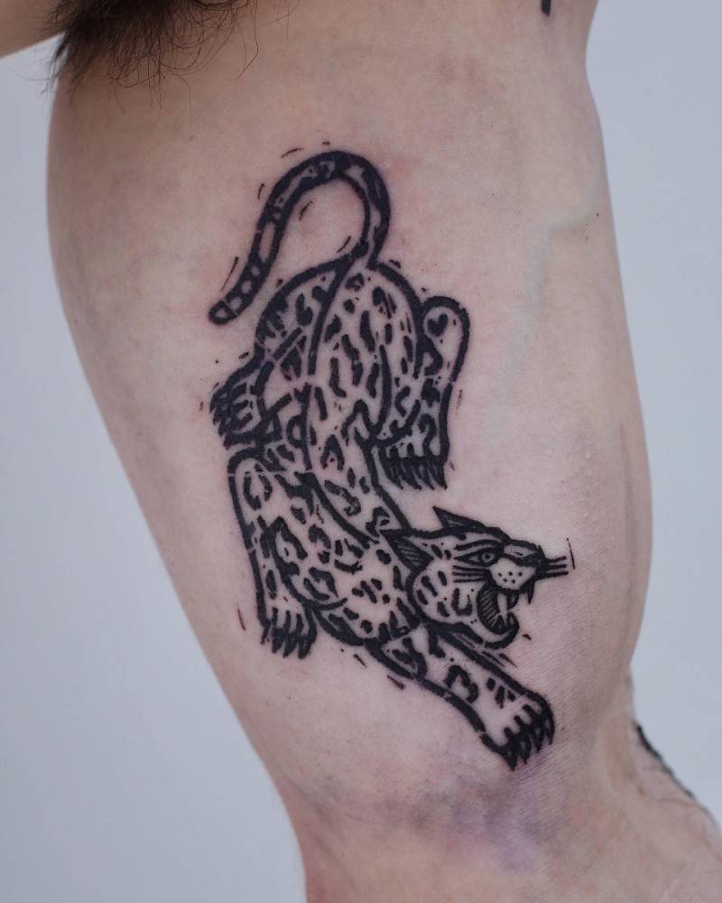 Pop art style leopard tattoo located on the inner arm.