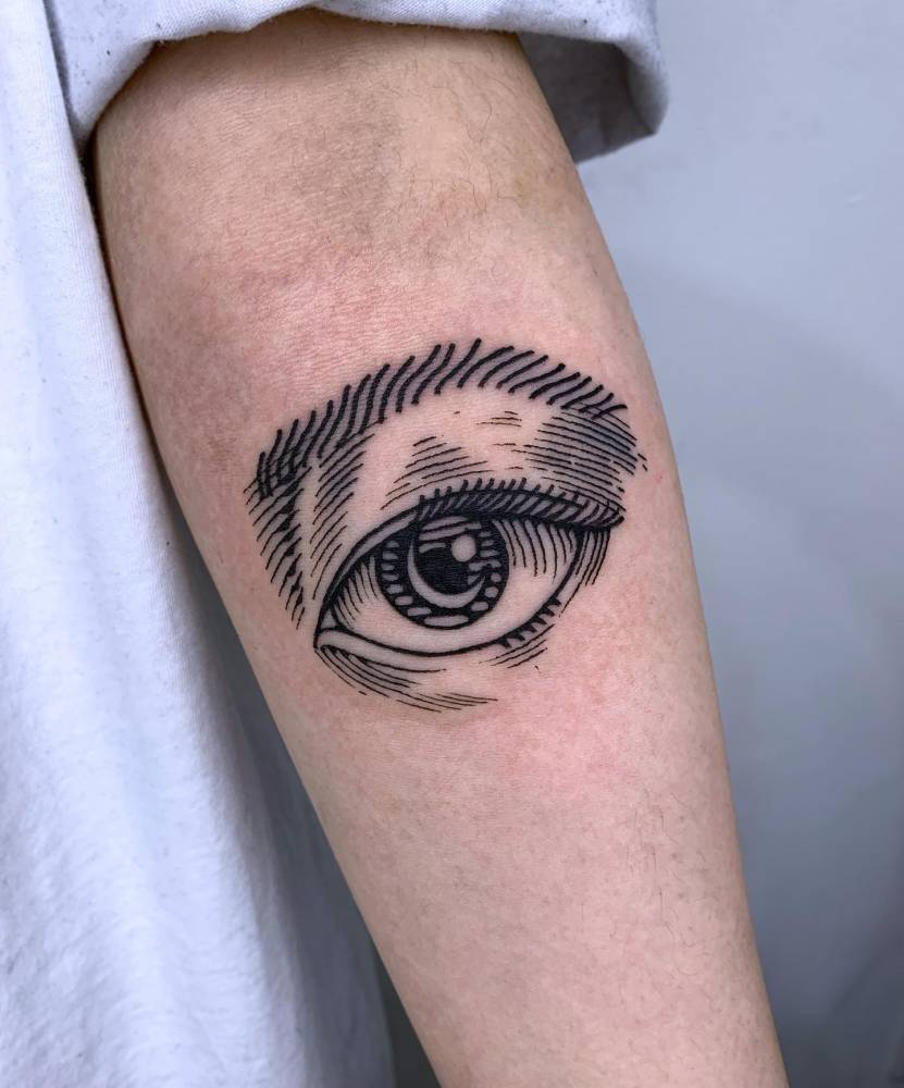 Engraving style eye tattoo located on the inner forearm.
